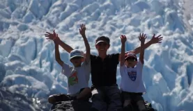 Family pose in front of an Alaskan glacier