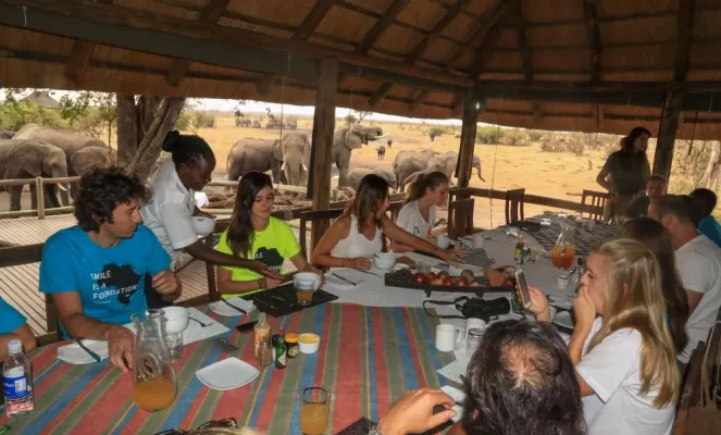 Open air dining with elephant backdrop